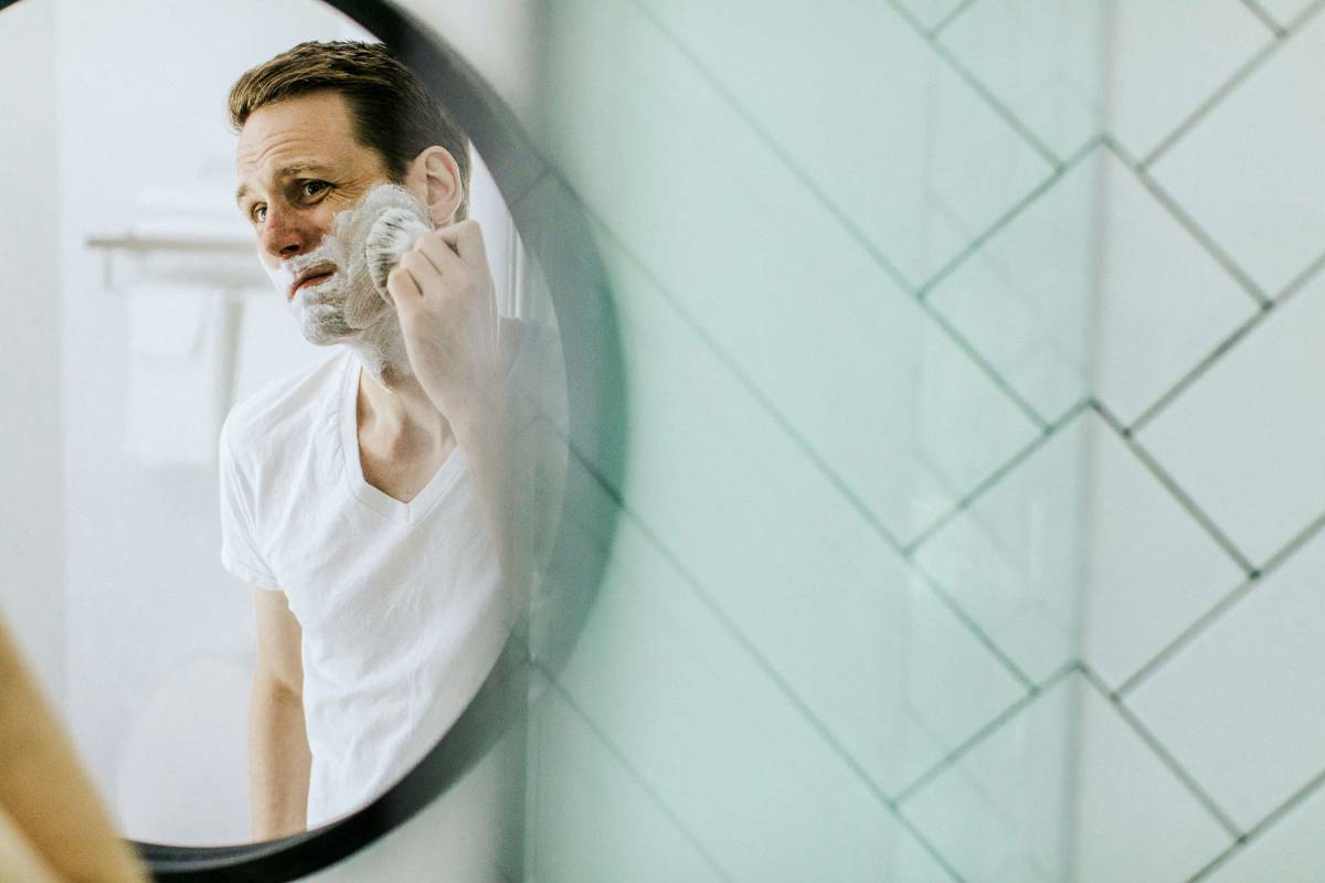 Infographic comparing synthetic vs natural shaving cream ingredients showing skin barrier impact